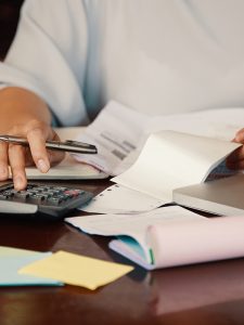 Haufe Steuer Hands of female entrepreneur working with bills and documents